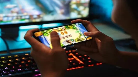 Child Playing Video Game Online On Mobile Landscape Mode. online gaming self-regulation agency