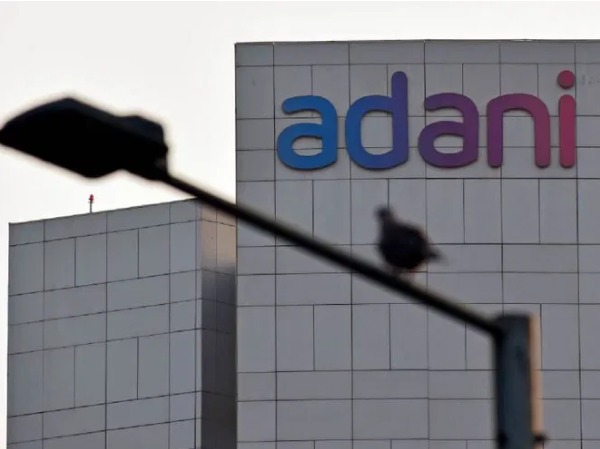 Adani group companies cuts revenue growth target, capex amid rout.